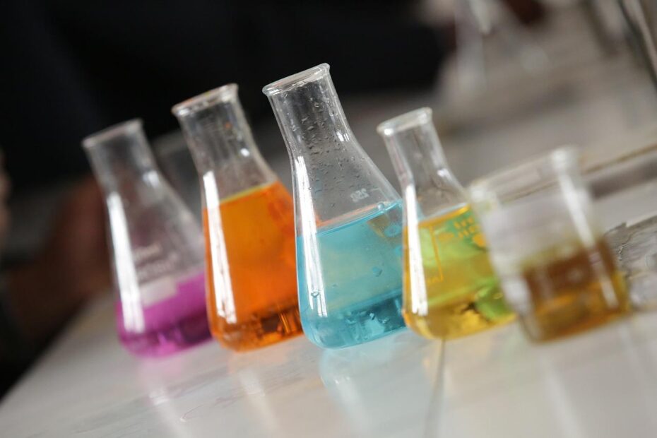 a group of beakers with different colored liquids